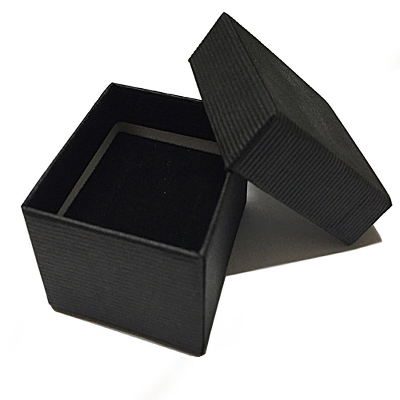 May include: A black square-shaped gift box with a black lid. The box is lined with black velvet.