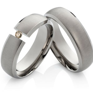 Titanium wedding rings set with a beautiful diamond image 1