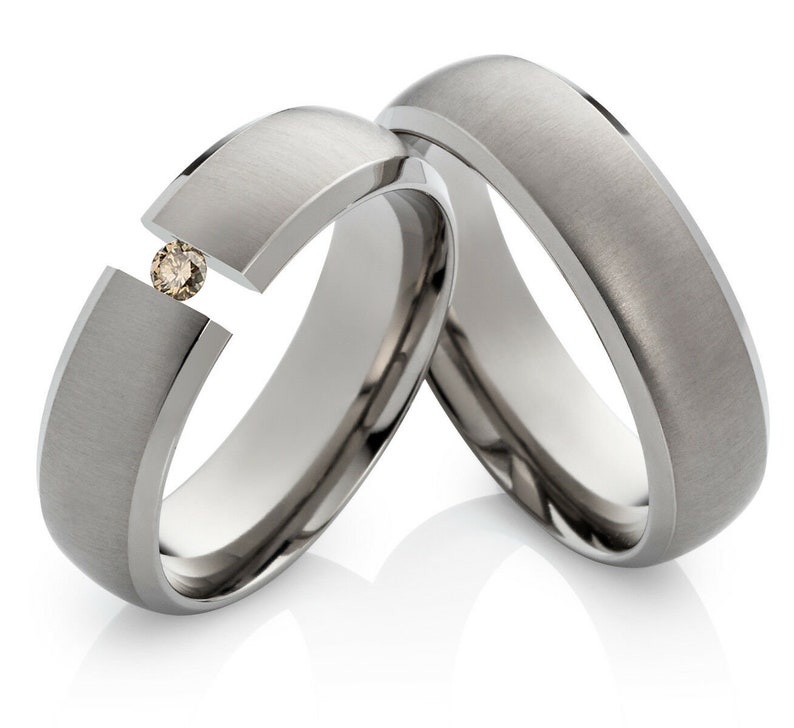 Titanium wedding rings set with a beautiful diamond image 1