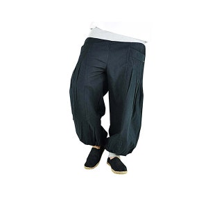 May include: Black harem pants with a relaxed fit. The pants have a gathered ankle and a pleated design on the front. The model is wearing black shoes. The pants are made of a soft, flowing fabric.