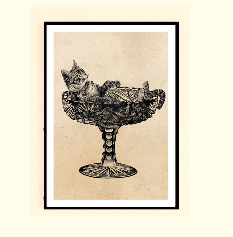 May include: A black and white illustration of a cat relaxing in a crystal bowl. The bowl has a decorative, cut-glass design and a pedestal base.