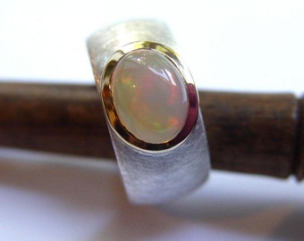 Ring with opal in gold and silver hand forged