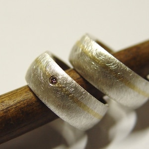 Wedding rings in silver and gold with brilliant