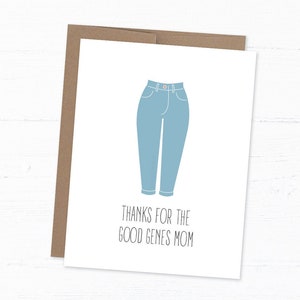 White card with illustration of mom jeans with "thanks for the good genes mom" written below. With kraft envelope behind and white wood background.