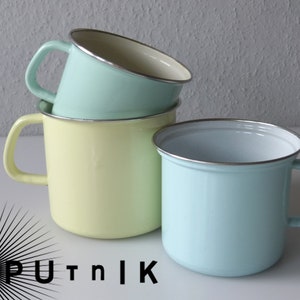May include: Three enamel mugs stacked on top of each other. The top mug is light blue, the middle mug is yellow, and the bottom mug is light blue.