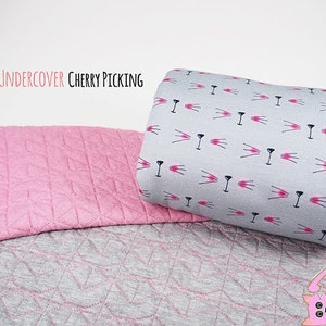 May include: Two pieces of fabric, one pink with a diamond pattern and one gray with a repeating pattern of pink cat faces. The text "MIOW UNDERCOVER CHERRY PICKING" is at the top of the image.