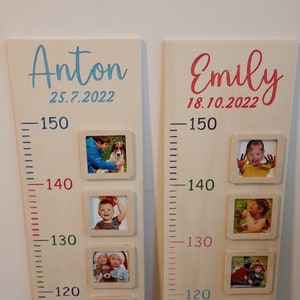 May include: Two wooden growth charts with a ruler and photo frames. The chart on the left is for Anton, born on 25.7.2022. The chart on the right is for Emily, born on 18.10.2022. Each chart has five photo frames with pictures of children.