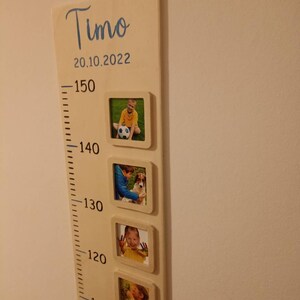 Pode incluir: Um gr&aacute;fico de crescimento de madeira com fundo branco e marcas pretas. O gr&aacute;fico &eacute; etiquetado como "Timo" e "20.10.2022". Existem cinco molduras com fotos de uma crian&ccedil;a em diferentes idades.