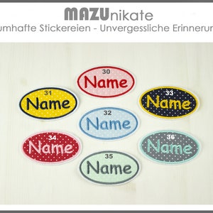 Könnte beinhalten: Sechs ovale Bügelbilder mit weißen Punkten. Jedes Bügelbild hat einen weißen Umriss und das Wort "Name" in schwarzer Schrift. Die Bügelbilder sind mit 30, 31, 32, 33, 34 und 36 nummeriert.