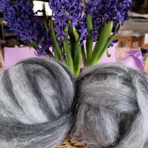 May include: A white ceramic mug with a black handle and the text "But First, Coffee" in a black, handwritten-style font. The mug is on a white surface.