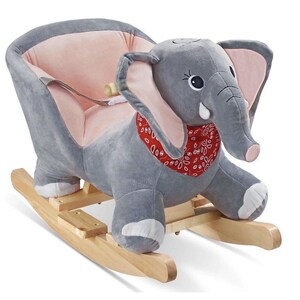 May include: A plush elephant rocker featuring soft grey fabric, large ears with pink inner lining, and a red bandana with a white pattern around the neck. The elephant is mounted on a light-coloured wooden rocking base with a seat and safety strap.