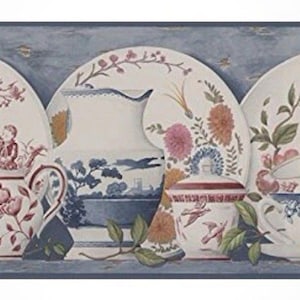 May include: Wallpaper border featuring a collection of vintage porcelain dishes and teacups. The designs include floral patterns, butterflies, and scenes in shades of red, blue, and peach. Green leaves and a blue background complete the design.