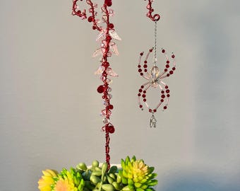 Red and pink twisted wire and beaded spider plant stake sun catcher