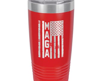 May include: A red insulated tumbler with a silver lid. The tumbler features a distressed American flag design with the letters "MAGA" vertically aligned on the left side. The flag's stars are visible.