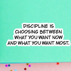 May include: A green background with a white sticker that reads "DISCIPLINE IS CHOOSING BETWEEN WHAT YOU WANT NOW AND WHAT YOU WANT MOST."