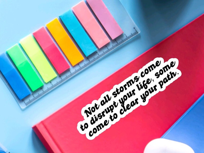 May include: A white sticker with black text on a red surface. The text reads "Not all storms come to disrupt your life, some come to clear your path."