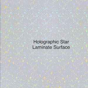 May include: A silver background with a holographic star pattern. The text "Holographic Star Laminate Surface" is printed in black.