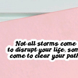 May include: A pink background with a white sticker that reads "Not all storms come to disrupt your life, some come to clear your path."