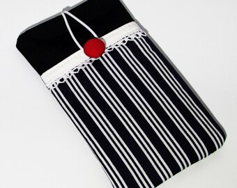 May include: A black and white striped fabric phone case with a white lace trim and a red button.
