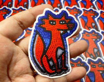 May include: A red and blue beaded fox sticker. The fox is sitting on its haunches with its tail curled around its body. The sticker is on a white background.