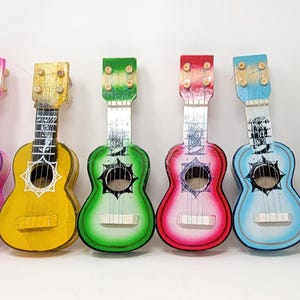 Packs of little mini  mexican toy guitars  10 inches tall party favors