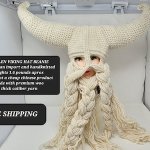 May include: A white crocheted Viking hat with horns and a long braided beard. The hat is made with thick yarn and weighs 1.6 pounds. "WOOLEN VIKING HAT BEANIE all mexican import and handknitted weights 1.6 pounds aprox this is not a cheap chinese product made with premium woo thick caliber yarn FREE SHIPPING TRUSTED USA SELLER" is written on the image.