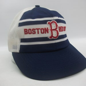 May include: A blue and white striped baseball cap with a red "Boston Red Sox" logo. The cap has a mesh back.