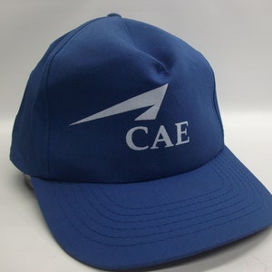 May include: A blue baseball cap with a white airplane logo and the text "CAE" embroidered on the front.