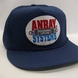 May include: A blue baseball cap with a white, red, and blue embroidered patch that says "Anray Horizontal Lifeline Systems".