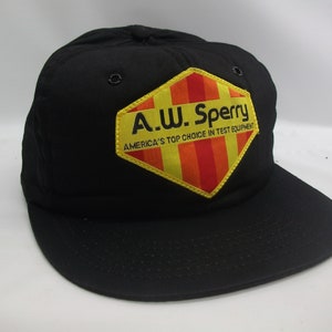 May include: Black baseball cap with a yellow and red diamond-shaped patch that says "A.W. Sperry America's Top Choice in Test Equipment"