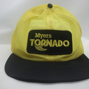 May include: Yellow and black mesh trucker hat with a black patch that says "Myers Tornado" in yellow lettering.