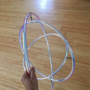 May include: A set of three iridescent hoops, each with a silver chain attached. The hoops are intertwined and appear to be made of plastic.