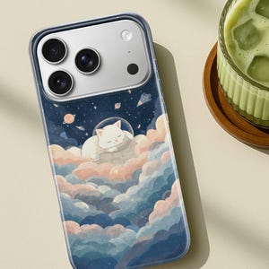 May include: A clear phone case featuring a whimsical illustration of a white cat sleeping peacefully on a cloud, set against a starry night sky with planets. The case has a blue border and is designed for a smartphone.