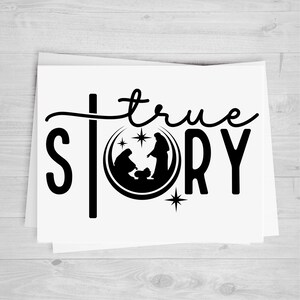May include: A stack of white cards with a black graphic design. The design features the words "true story" with a silhouette of the nativity scene inside a circle. The letter "S" is stylized as a cross.
