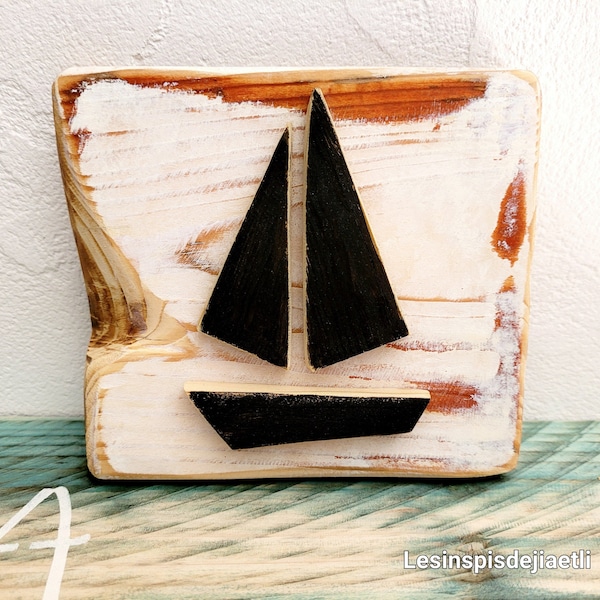 Small seaside wooden painting, wooden wall decoration, minimalist aged black sailboat. Marine interior.