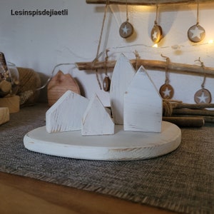 Village in white recycled wood, small houses Nordic christmas decorations, Scandinavian chalet atmosphere.