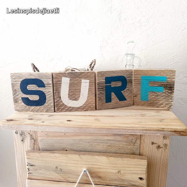 Surf decoration in blue and white recycled painted wood, surf letters painted on wood, seaside style interior.
