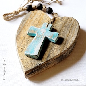 Large rustic wooden heart with small blue wooden cross. Gift, religious object, decoration made from reclaimed wood.