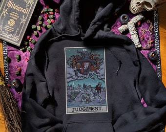 May include: Black hoodie with a graphic print of a tarot card depicting a witch with the text "Judgement".