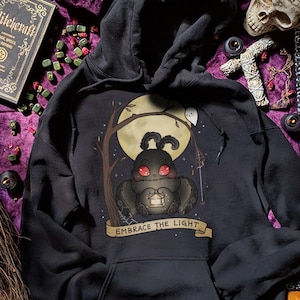 Embrace The Light Baby Mothman Hoodie Spooky Cute Hoodies Cryptid Merch Goth Clothing Gothic Sweatshirt Halloween Sweater Adorable Horror