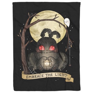 May include: A black and brown moth with red eyes holds a lantern in its paws. The moth is sitting on a branch under a full moon with a ghost in the background. The text "Embrace the Light" is written on a banner below the moth.