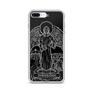 May include: A black and white illustration of the Temperance card from a tarot deck. The card features an angel pouring water from one cup to another, with a background of a building and a graveyard. The text "TEMPERANCE" is written at the bottom of the card.