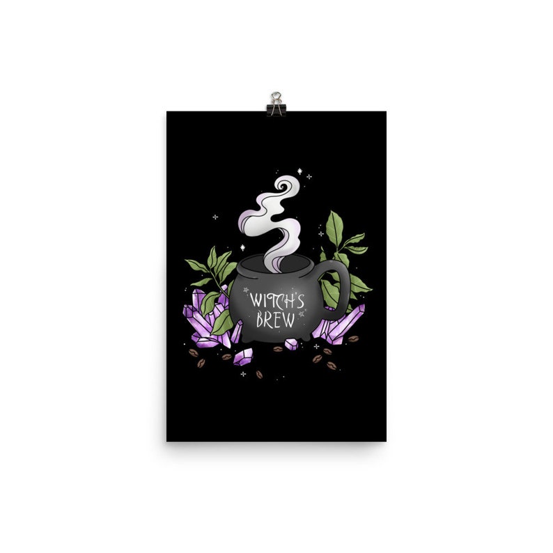 May include: A black cauldron with steam rising from it, surrounded by purple crystals and coffee beans. The cauldron has the text "Witch's Brew" on it.