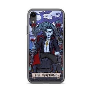 May include: A phone case featuring a tarot card illustration of The Emperor. The Emperor is depicted as a vampire, sitting on a throne, holding a glass of wine. The card is set against a dark, starry night sky.