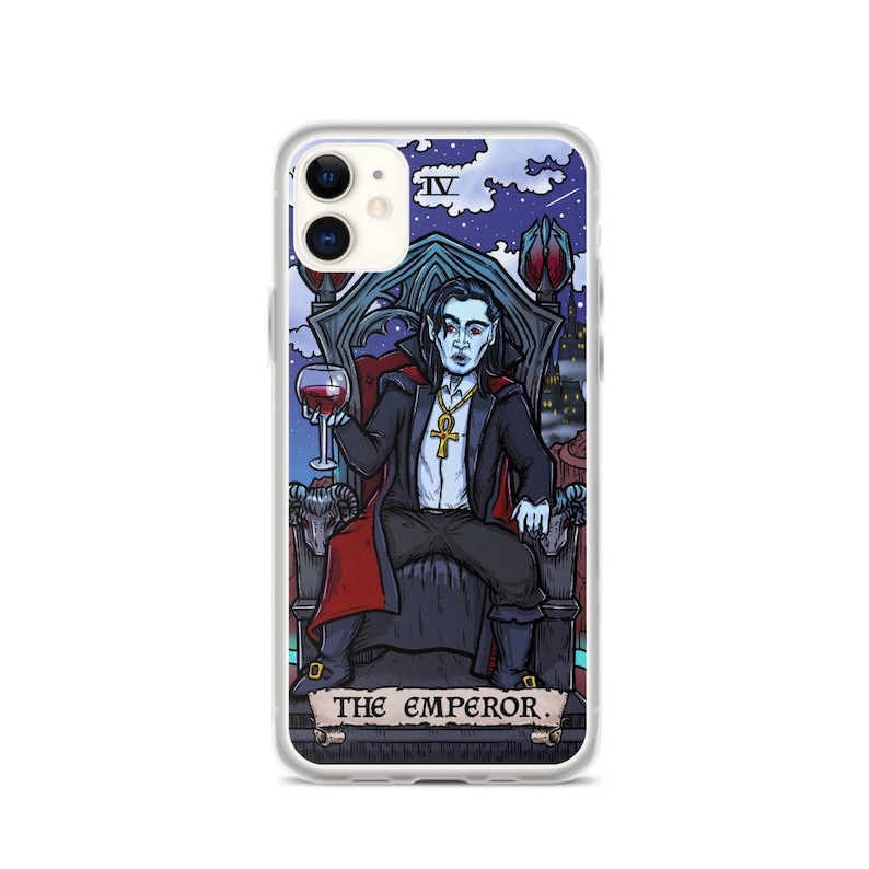 May include: A phone case with a clear background and a colourful illustration of a vampire on a throne. The illustration is in the style of a tarot card and includes the text "THE EMPEROR."