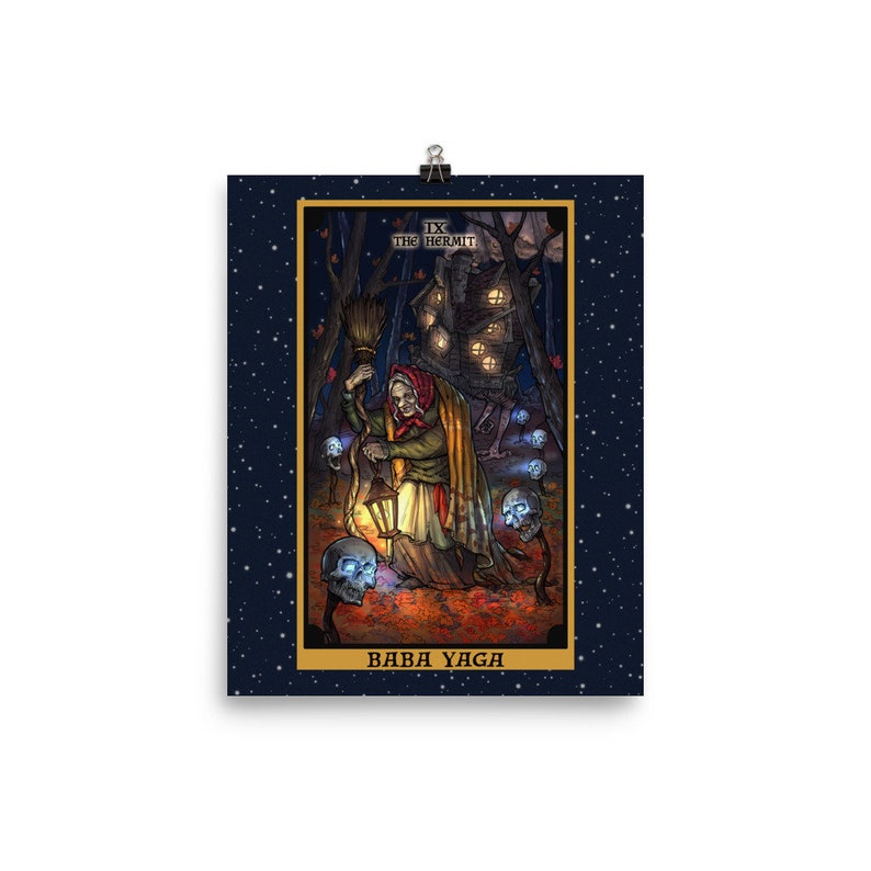 May include: A tarot card illustration of Baba Yaga, a witch from Slavic folklore, depicted as the Hermit card. The card is set against a dark blue background with white stars. The illustration features Baba Yaga holding a lantern and a broom, with a skull-like creature following her. The card is framed in gold and has the text "IX THE HERMIT" and "BABA YAGA" on it.