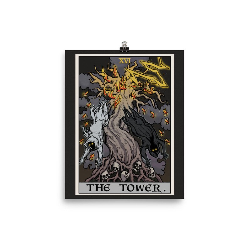 May include: A tarot card illustration of The Tower, depicting a burning tree with two figures falling from it. The card is black with gold accents and the text "XVI THE TOWER."