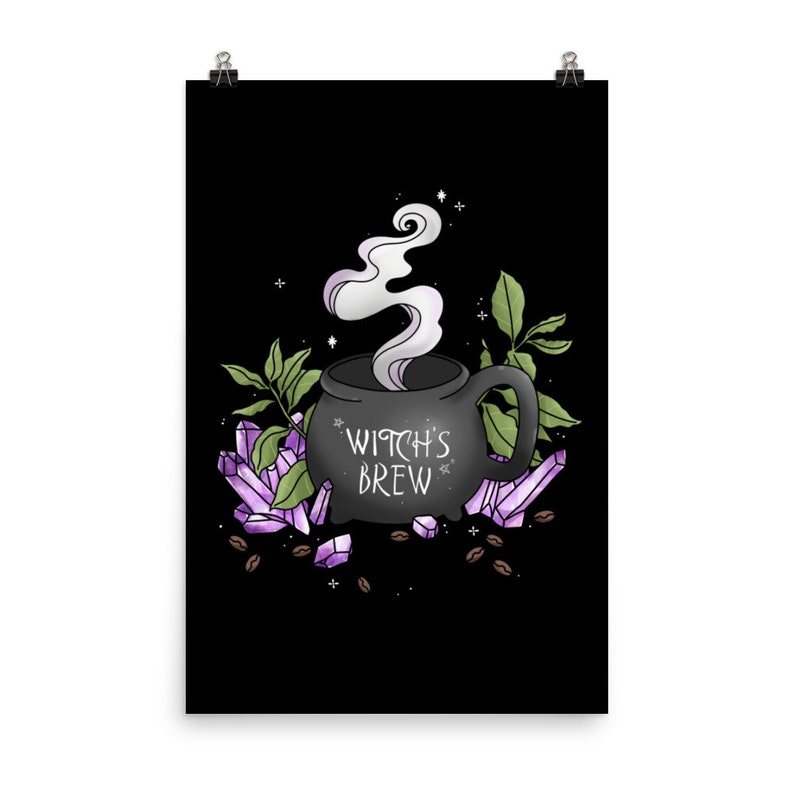 May include: A black cauldron mug with steam rising from it, surrounded by purple crystals and coffee beans. The mug says "Witch's Brew" in white lettering.