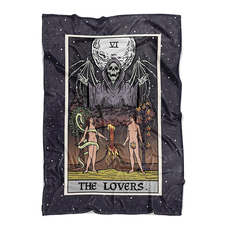 May include: A tarot card blanket featuring the Lovers card. The card depicts a couple standing in front of a large, dark figure with a skull face. The card is surrounded by a dark blue background with white stars.
