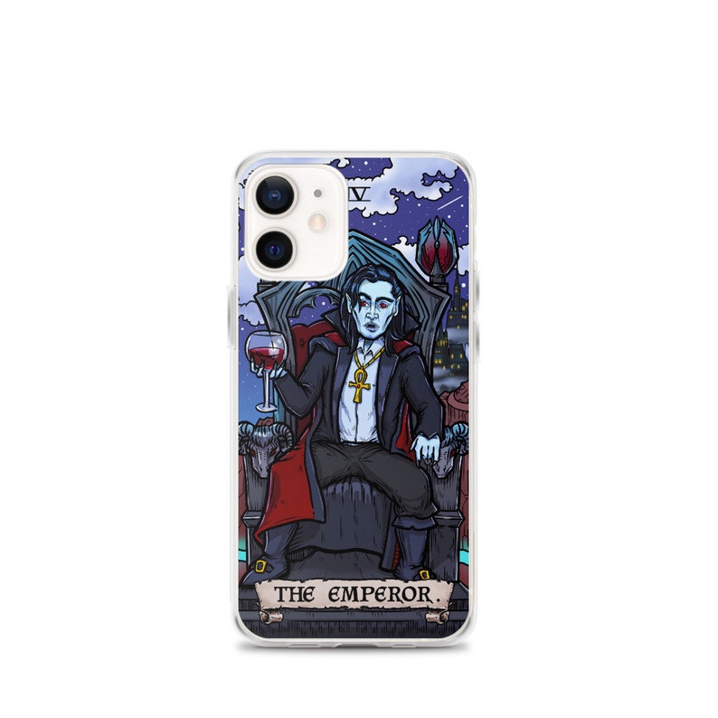 May include: A clear phone case featuring a colourful illustration of a vampire holding a glass of wine. The illustration is in the style of a tarot card and includes the text "THE EMPEROR."